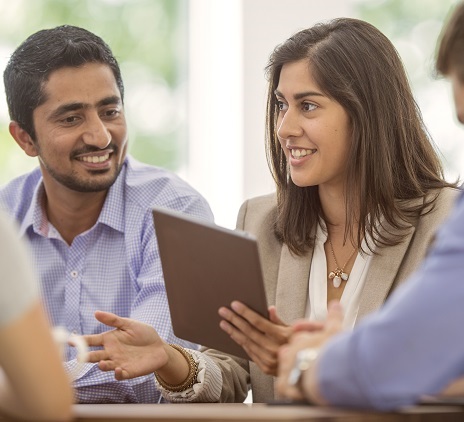 Two people talking with a tablet computer